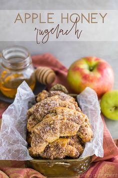 an apple honey muffin in a basket with some apples and honey on the side