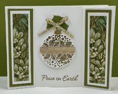 a christmas ornament card with the words peace on earth in gold and green