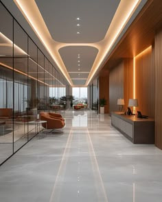 an empty lobby with modern furniture and large mirrors on the wall, along with floor to ceiling windows