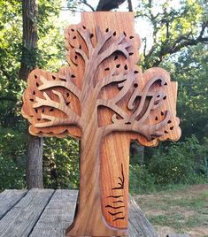 a wooden cross that has been carved into the shape of a tree