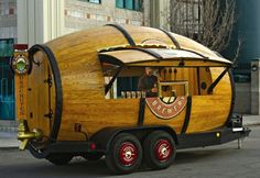 a wooden trailer with a man in the driver's seat on the back of it