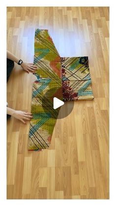 someone is making a rug on the floor with their hands and feet in front of them