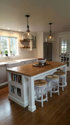 a large kitchen island with stools in it