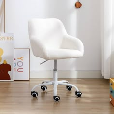 a white chair sitting on top of a wooden floor