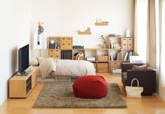 a living room filled with furniture and a flat screen tv sitting on top of a hard wood floor