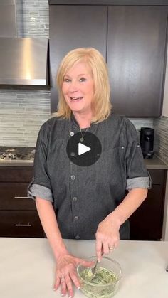 a woman standing in front of a counter with a bowl of food on top of it