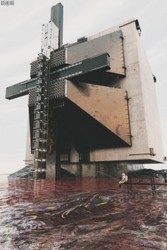 a large building sitting on top of a body of water next to a tall metal structure