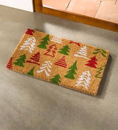 a door mat with christmas trees on it