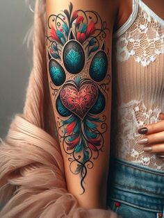 a woman's arm with a colorful tattoo design on her left shoulder and chest