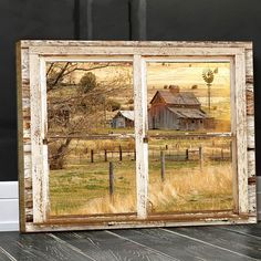 an old window with a barn in the background and light bulbs hanging from it's sides