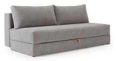 a gray couch with two pillows on it's back and the seat folded down