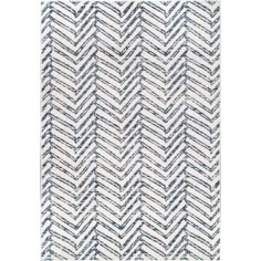 a rug with blue and white chevroned lines on it, in the shape of a zigzag pattern