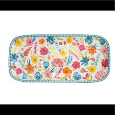 a rectangular tray with colorful flowers on the front and blue trimmings around it