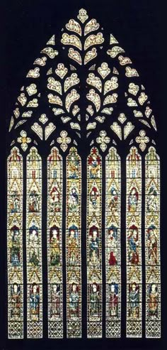 an old stained glass window with many different designs