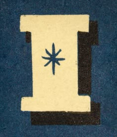 a blue and white piece of cloth with a black star on the center, in front of a dark blue background