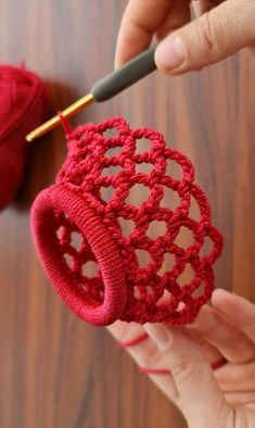 someone is crocheting an object with yarn