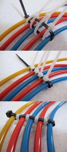 there are many different colored hoses on the floor and one is red, yellow, blue, and black