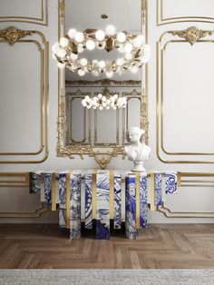 an elegant dining room with blue and white table cloths, chandelier and mirror