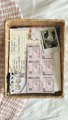 a basket filled with lots of items on top of a bed