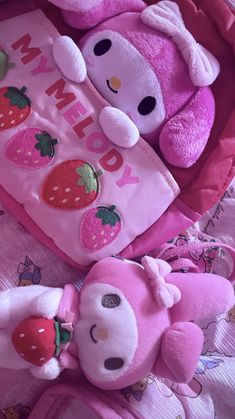 two pink teddy bears laying next to each other