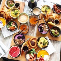 a wooden table topped with lots of different types of foods and drinks on top of it