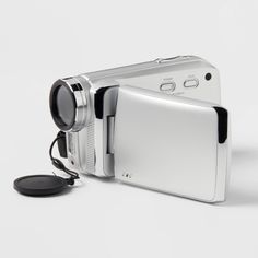 a silver camera sitting on top of a white table