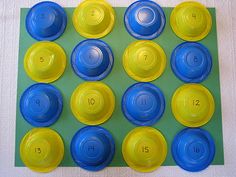 the blue and yellow cups are arranged in rows on top of each other with numbers