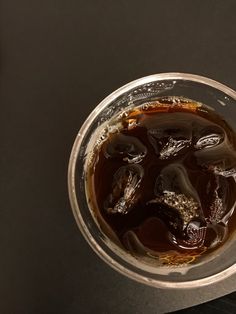 a glass filled with liquid sitting on top of a table