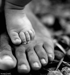 a black and white photo of a baby's feet