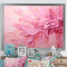 a large pink painting hanging on the wall above a bed with pillows and pillow cases