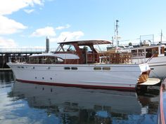 a white boat is docked in the water