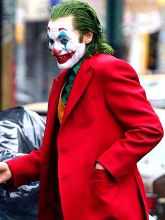 a man in a red suit and clown makeup