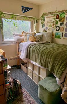 a bedroom with a bed, dressers and other items on the floor in front of a window