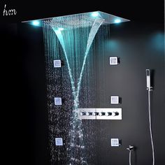 the shower head is illuminated with blue lights and water running down it's side