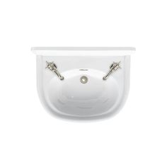 a white sink with two faucets on the side