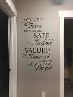 a bathroom wall with the words you are home here you are safe required to be insured and most likely loved