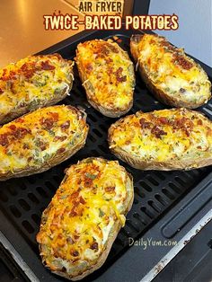 six baked potatoes sitting on an air fryer with the words twice - baked potatoes above them