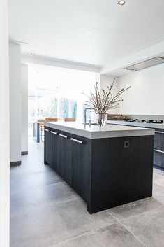 a large kitchen with an island in the middle