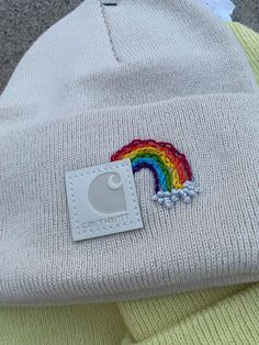 a white hat with a rainbow patch on it