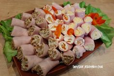 a platter filled with meat and veggies on top of a wooden table