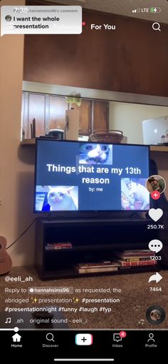 a flat screen tv sitting on top of a wooden stand in a living room next to a guitar