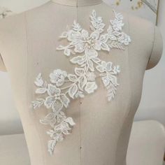 the back of a dress with white flowers on it