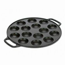 an empty cast iron muffin pan on a white background