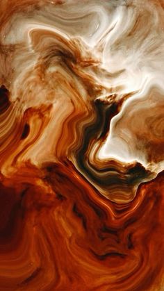 an orange and brown liquid is in the air