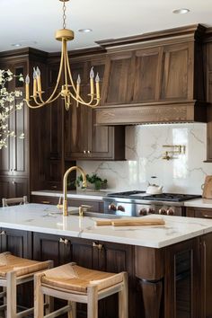 a large kitchen with wooden cabinets and marble counter tops, an island in the middle