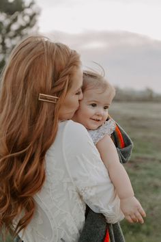 a woman holding a baby in her arms