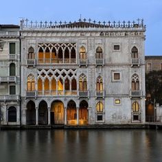 an old building sitting next to a body of water