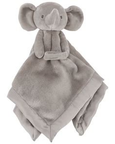 a gray stuffed animal on top of a blanket