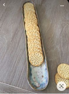 two crackers are sitting on a spoon next to each other and one is in the shape of a cookie