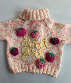 a knitted sweater with strawberries on it